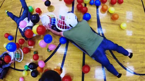 Human Hungry Hippos Played With Balloons On Wheeled Platforms Is