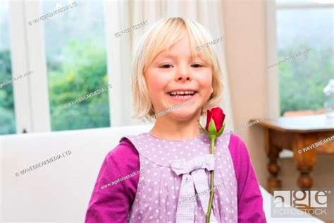Cute Little Girl Holding A Red Rose Stock Photo Picture And Low