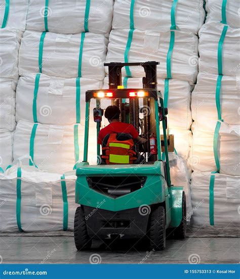 Forklift Operation in Warehouse, Lifting Cargo in Jumbo Bag into Stack
