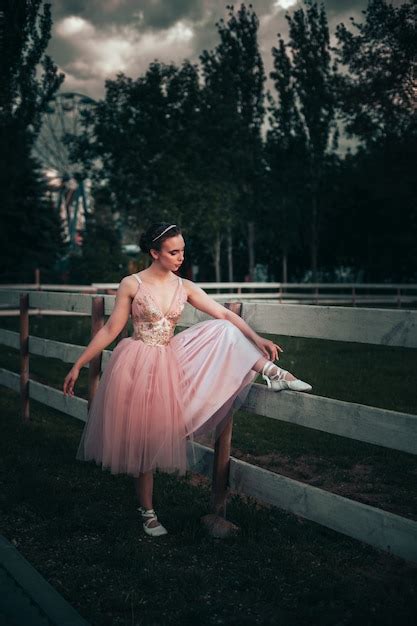 Premium Photo A Thin Ballerina Puts Her Foot On The Wooden Board Of