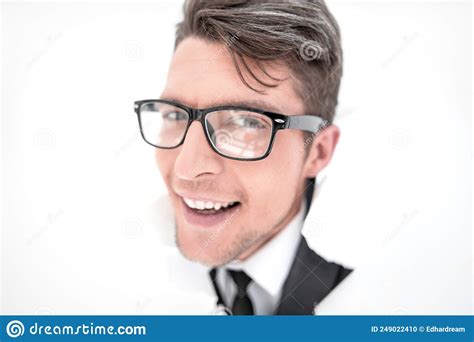 Confident Businessman Breaking Through A White Paper Wall Stock Photo
