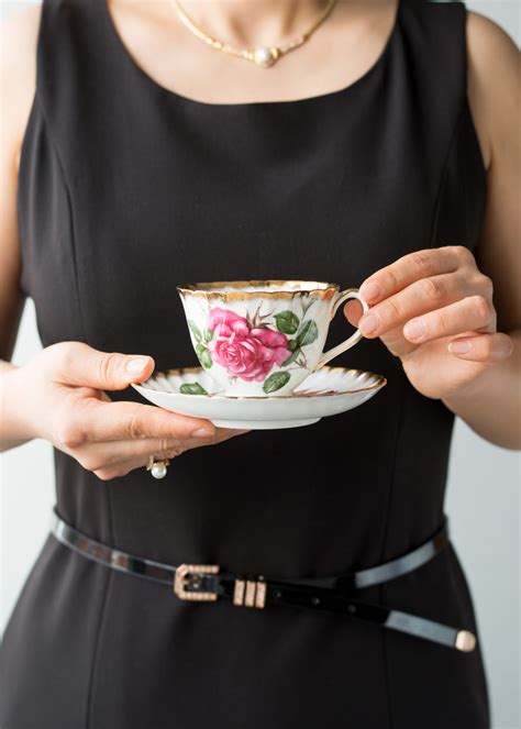 Female Hands Holding Teacup At A Social Occasion Kiss The Cook Catering