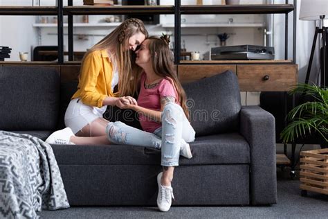 Two Smiling Lesbians On Sofa In Cozy Living Room Stock Image Image