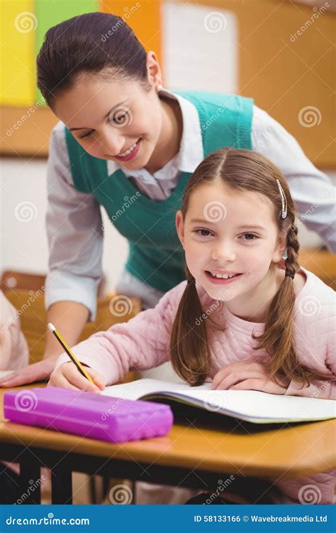 Teacher Helping A Little Girl During Class Stock Photo Image Of
