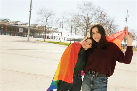 couple lesbian woman with gay pride flag in barcelona photograph by cavan images pixels