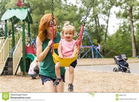 Mother And Daughter In A Swing Having Fun At The Park Playground Stock Image Image Of Houston