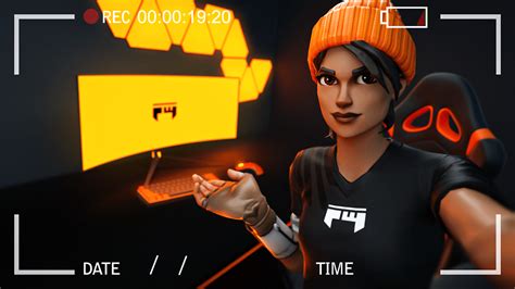 A Woman In A Black Shirt And Orange Hat Is Holding A Computer Mouse While Wearing An Orange Beanie