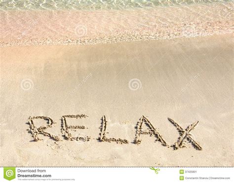 Relax Word Written In The Sand On A Beautiful Beach With Clear Blue