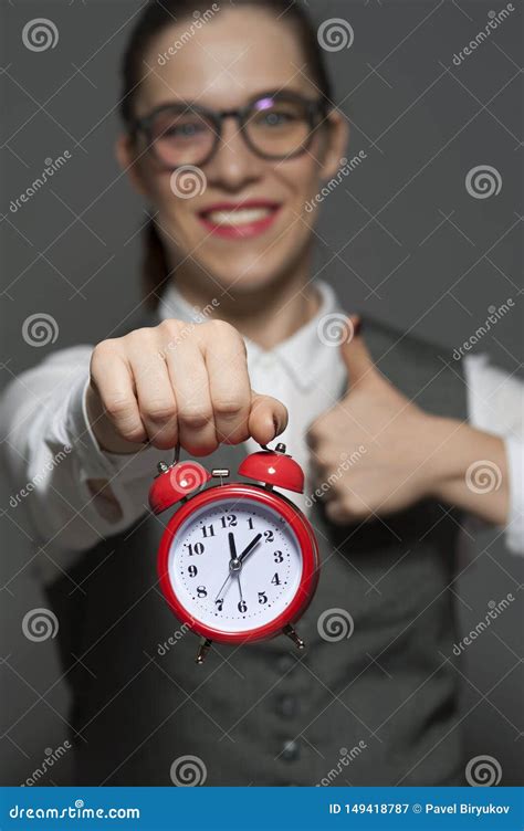 Close Up Of Young Businesswoman Or Office Worker Holding Red Clock In