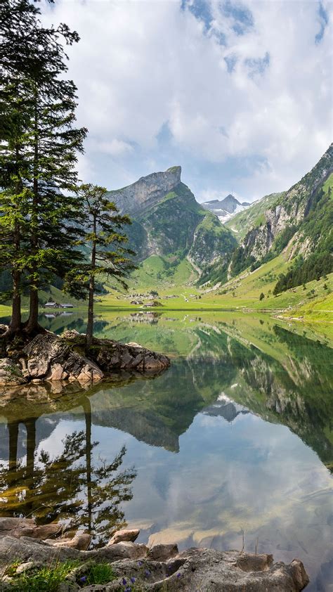 Clouds Over Mountain Range With Reflection In Lake Canton Of Appenzell