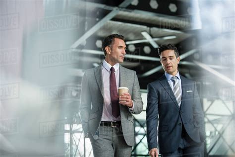 Corporate Businessmen Walking With Coffee Stock Photo Dissolve