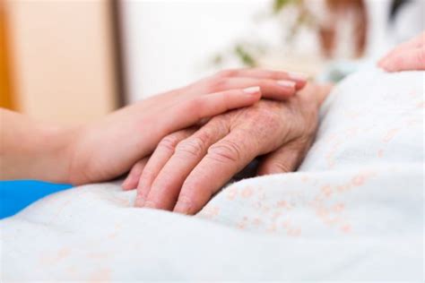 Nurse Holding The Hand Of An Elderly Woman Stock Photo By ©lighthunter