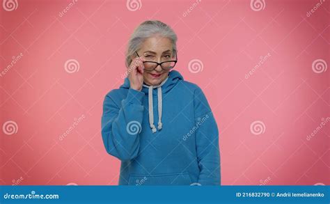 Happy Playful Elderly Granny Woman Blinking Eye Looking At Camera With Smile Expressing