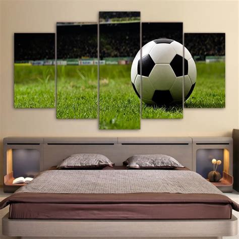 A Soccer Ball Sitting On Top Of A Bed With Green Grass In The Foreground