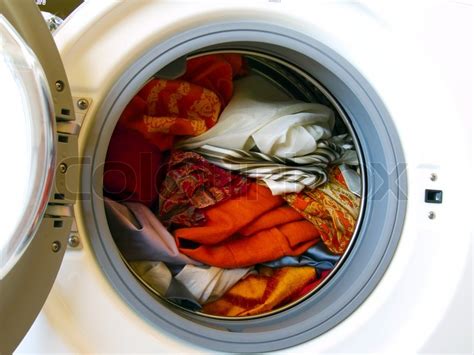 Phenolic disinfectants may be added to the wash or rinse water if the rinse water is warm. Washing machine with colored clothes laundry | Stock Photo ...