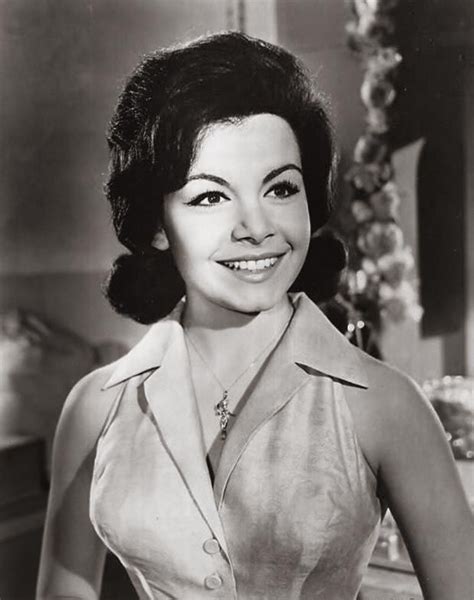 An Old Black And White Photo Of A Woman In A Dress Smiling At The Camera