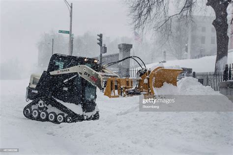 A Snow Plow Cleans The Area Around The State House On Beacon Street
