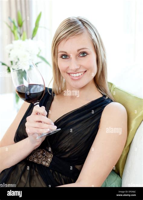 Beautiful Woman Drining Red Wine Sitting On A Sofa Stock Photo Alamy