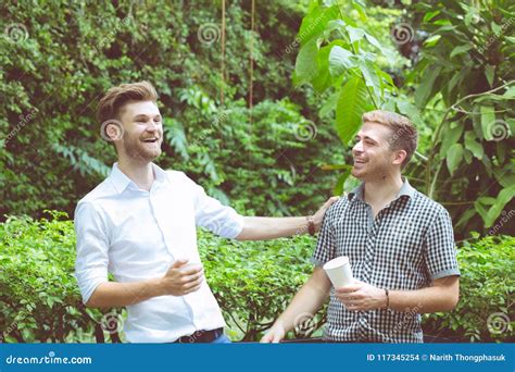 Two Friends Men Talking Standing In A Garden Stock Photo Image Of