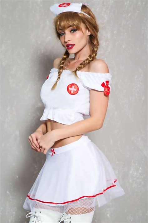 A Woman Dressed In White And Red Is Posing With Her Hands On Her Hips