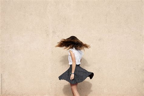 Unrecognizable Young Woman In Turning Motion Flying Hair And Skirt