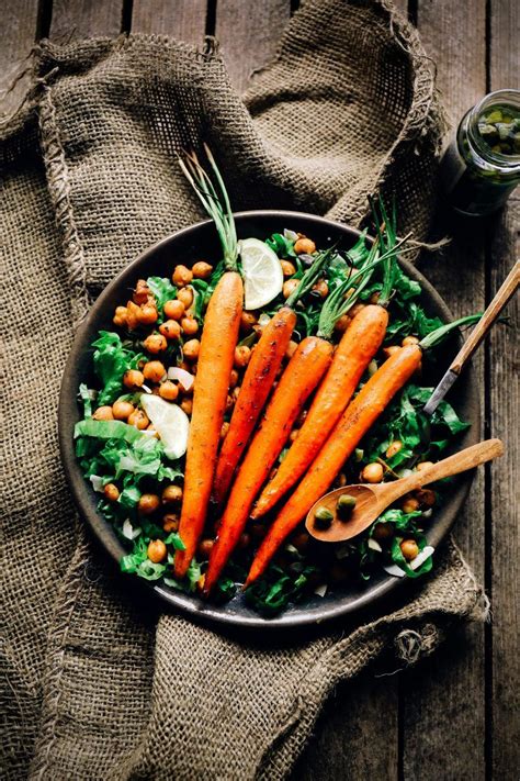 Most people make glazed carrots by cooking them in a pot on the stovetop, but if you haven't tried baking them in the oven, you're missing out. Baked carrots on a chickpeas salad