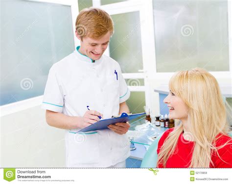 Female Patient In Dentist Office Answering Doctor Questions Stock