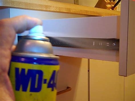 Slide the drawer in and out of the cabinet. Fix my Cabinet » Spray WD-40 on Drawer Slides