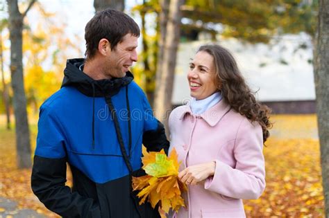 Romantic Couple Posing In An Autumn Park Beautiful Nature And Trees With Yellow Leaves Stock