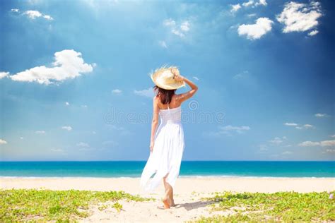 Beautiful Young Woman Standing On The Sand Beach And Looking At Stock