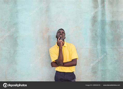 Handsome Young Black Man Thinking Hard — Stock Photo © Olly18 228303418