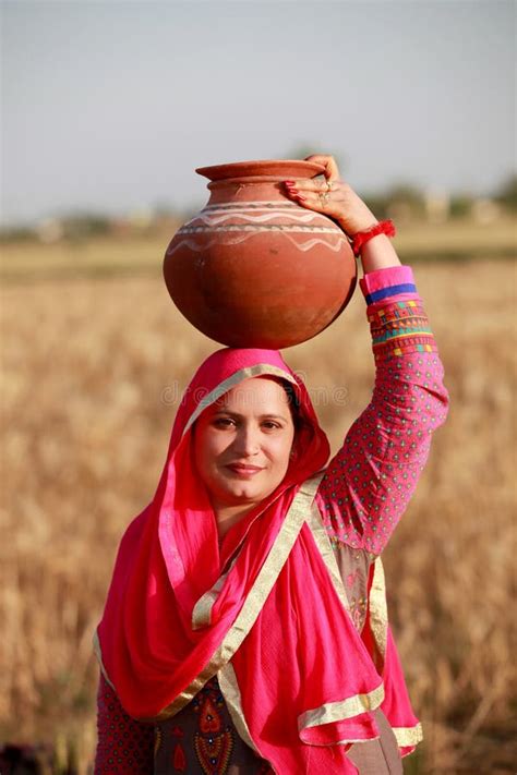 Indian Rural Women Taking Water Pot On Her Head Standing Into