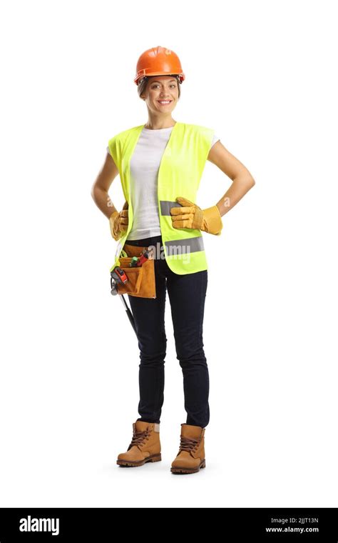 Full Length Portrait Of A Female Construction Worker Wearing A Helmet