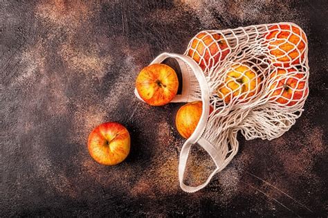 Premium Photo Fresh Apples In A Mesh Bag On The Table