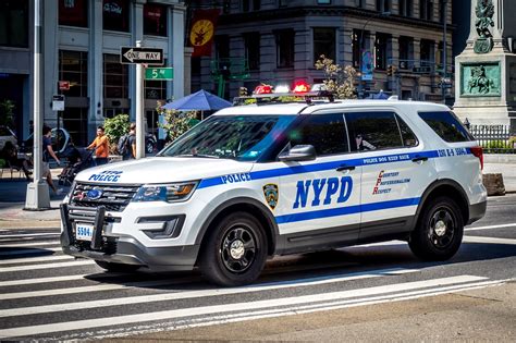 A Nypd Police Car Driving Down The Street