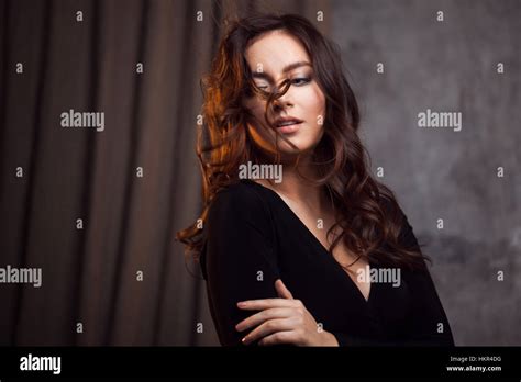 Delightful Portrait Of A Woman Brunettes Hair Flying On The Wind Sloppy Styling Stock Photo