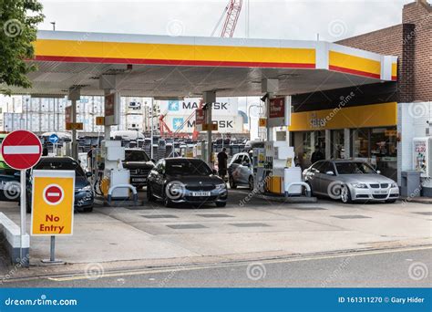 Drivers Filling Up With Fuel At A British Shell Petrol Station With