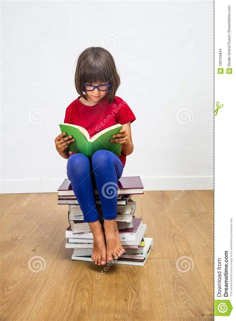 Beautiful Young Schoolgirl With Eyeglasses Reading For Culture Power