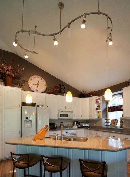 Track lighting systems are easy to install on the cathedral ceiling because you can install them on the beam of the ceiling. Kitchen lighting | Vaulted ceiling lighting, Track ...