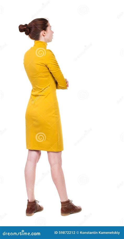 Back View Of Standing Young Beautiful Woman In Dress Stock Photo