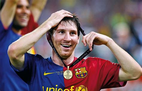 lionel messi of barcelona celebrates victory with his winner s medal round his head after his
