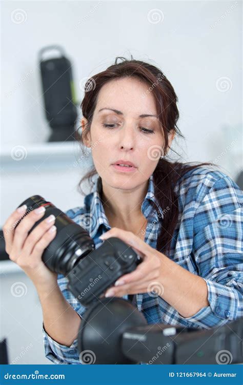 Professional Photographer Showing How To Use Camera Gear Stock Photo