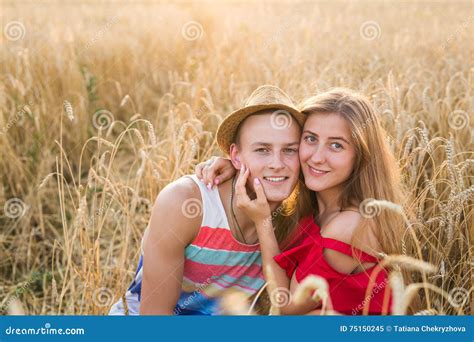 Happy Outdoor Portrait Of Young Stylish Couple In Summer In Field