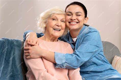 Premium Photo Happy Senior Mother And Adult Daughter Embracing With Love On Sofa Old Mother