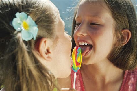 Italy South Tyrol Two Girls 6 7 10 11 Licking Lollypop Portrait