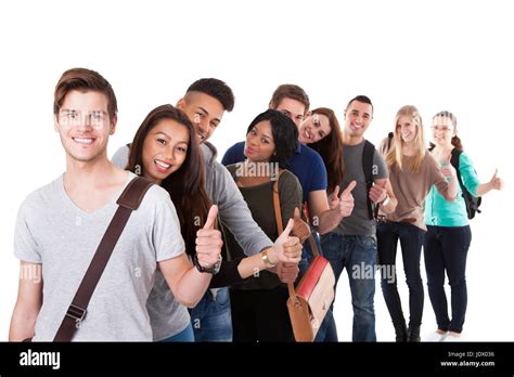 Portrait Of College Students Gesturing Thumbs Up While Standing In A