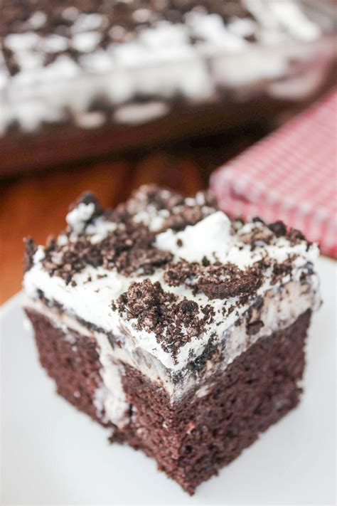 A moist chocolate cake recipe full of oreo icing and crushed up oreos. Oreo Poke Cake | TheBestDessertRecipes.com