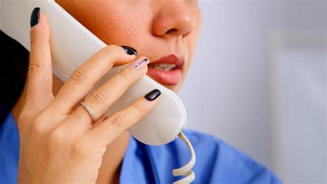 Premium Photo Close Up Of Medical Receptionist Answering Phone Calls