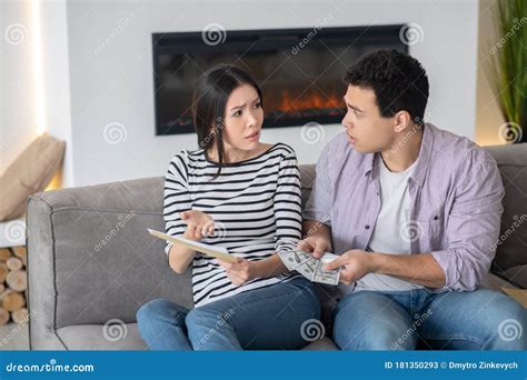 Young Husband And Wife Talking Seriously On The Couch Stock Image Image Of Serious Despair