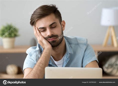 Bored Sleepy Man Feels Drowsy Resting On Hand Near Laptop — Stock Photo